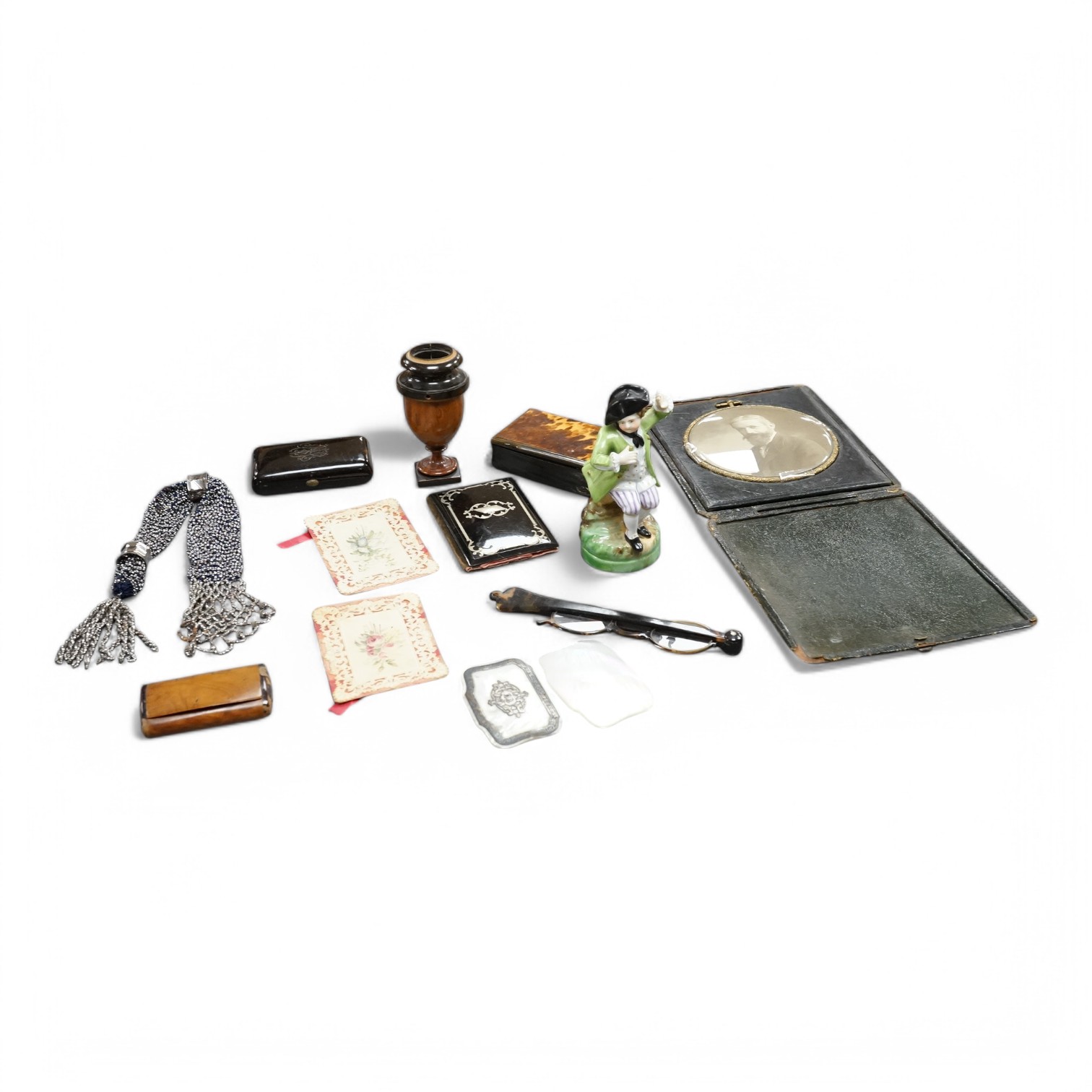 A collection of various objets de vertu to include snuff boxes, tortoiseshell glasses and a Continental figure. Condition - varies